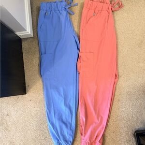 Two pairs of woman's medium Hanes jogger style scrub pants in pink and blue